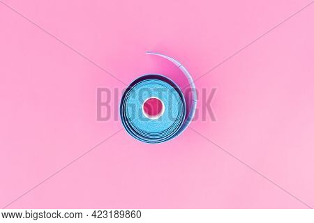 Blue Roll Of Kinesiology Tape On Light Pink Background With Copy Space, Flat Lay. Recovery, Anti-agi