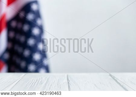 Us Flag Background. American Flag With White Wood Table And Copy Space.