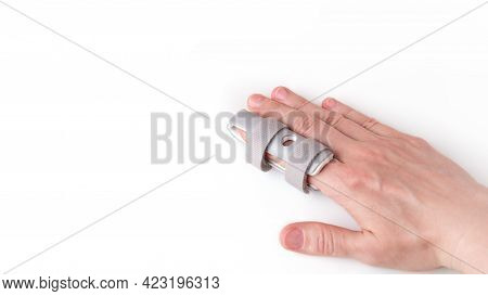 Grey Plastic Two-sided Finger Splint With Two Convenient Hook-and-loop Straps On An Broken Index Fin