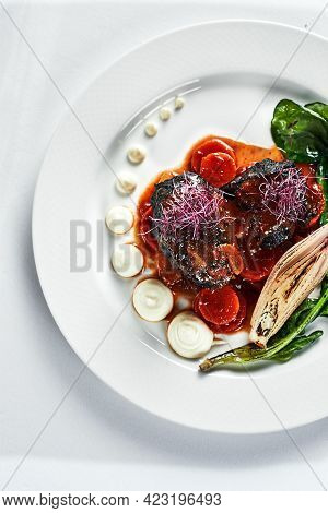 Braised Beef Cheeks With Vegetables On A White Plate Cooking Beef Cheeks In Demigas Sauce With Grill