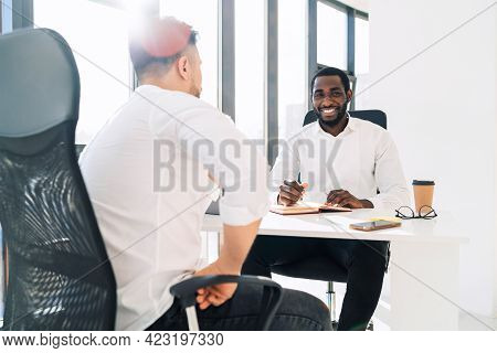 Company Manager Conducts Interview For A Man. \ntwo Mulracial Office Workers