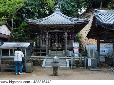Imabari, Japan - April 11, 2018: O-henro Pilgrim On The Grounds Of Senyuji, Temple Number 58 Of Shik
