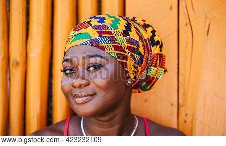 African Woman With A Hopeful Happy Smile Standing Against A Bamboo Wall In The Tropical Fishing Vill