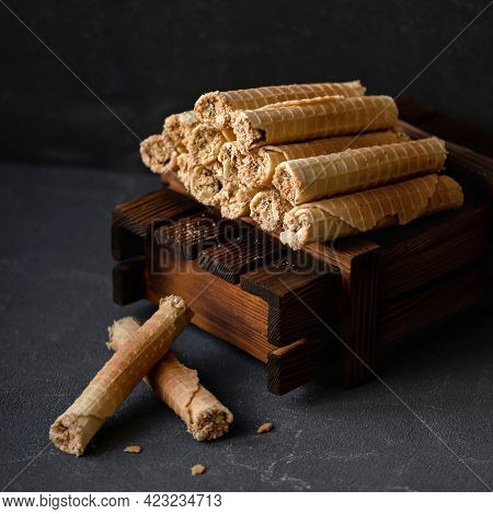 Pyramid Of Waffle Rolls On Gray Background. Sweet Rolls Filled Or Stuffed With Condensed Milk. Wafer