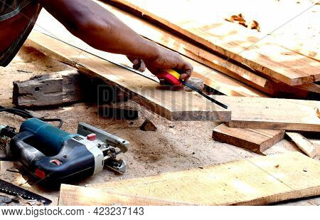 Carpenter Ccaucasian Man Using Measuring Tape Looking Wood Size At Workspace. Craftsman Profession I
