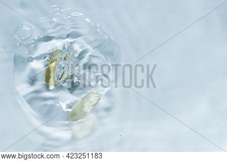 Beauty Skin Care Product. Water Drop Background. Hyaluronic Serum. Vitamin Drop Pill Capsule. Health