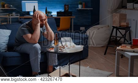 Exhausted Frustrated Depressed Young Man Massaging Temples Having Mental Problems. Stressed Unhealth