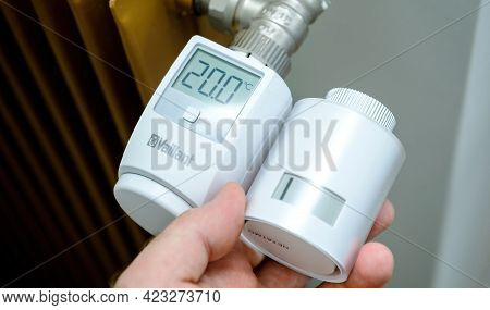 Paris, France - Apr 21, 2021: Pov Male Hand Holding Netatmo By Stark Intelligent Radiator Thermostat