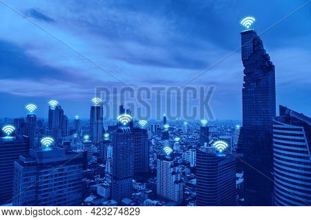 Aerial View Of Modern Cityscape With Wifi Icons, Technology For Smart City. Wireless Communication. 