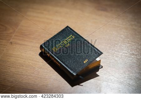 Bible In The Light Wooden Background. The Holy Bible.the Old Holly Bible Closed.black Holly Bible On