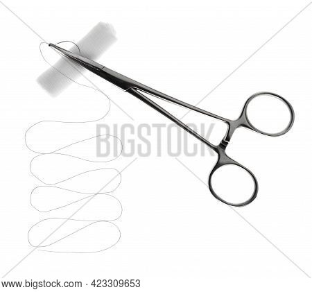 Forceps With Suture Thread And Bandage Roll On White Background, Top View. Medical Equipment