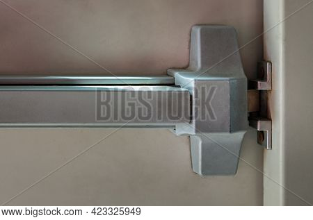 Close-up Of Latch And Door Handle Of Emergency Exit. Push Bar And Rail For Panic Exit. Open One Way 