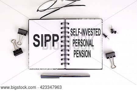 Notebook With Self-invested Personal Pension Sipp On A Table, Business
