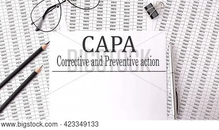 Paper With Corrective And Preventive Capa Action Plans On A Table With Chart And Pencils
