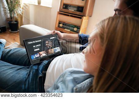 Video On Demand, Tv Streaming, Multimedia. Couple With Tablet