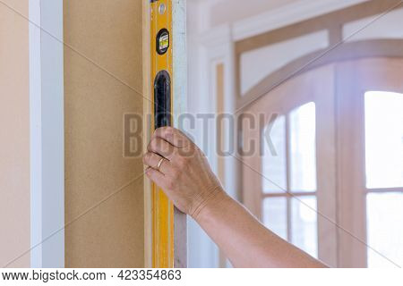 Wood Columns Using Level In Check Appropriate Under Construction In Worker Using Leveling Instrument