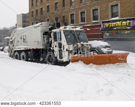 Bronx, New York/usa - February 1, 2021: Sanitation Truck Shovels Snow During Storm On Local Street.