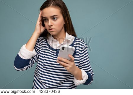 Photo Of Thoughtful Concentrated Attractive Young Brunette Girl Wearing Striped Longsleev Standing I