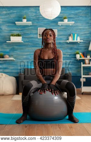 Sportive Active Strong Black Woman Sitting On Stability Ball Resting, After Intense Training In Home