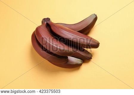 Tasty Red Baby Bananas On Yellow Background, Top View