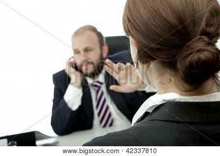 Business Man And Woman At Desk Sign Quiet On Phone