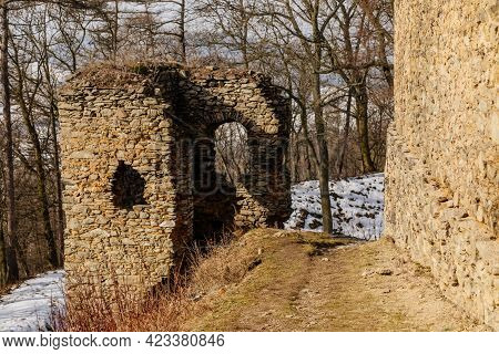 Medieval Gothic Castle Kostomlaty Or Sukoslav Under Snow, Grey Stone Ruin On Hill At Sunny Winter Da