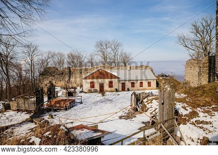 Medieval Gothic Castle Kostomlaty Or Sukoslav Under Snow, Grey Stone Ruin On Hill At Sunny Winter Da