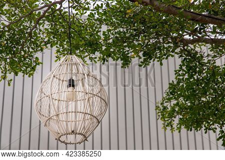 White Antern Lamp Of Woven Bamboo Hanging From The Trees To Decorate In Park. Lighting Decoration, A