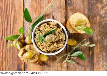 green olive tapenade and tree branch