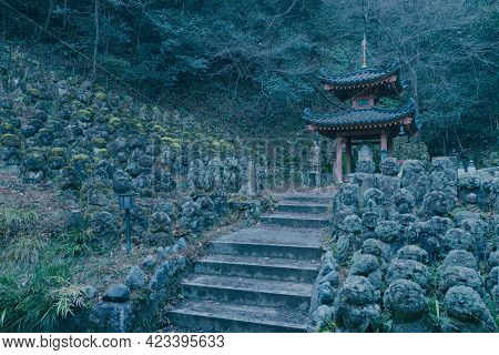 Evening Near Historic Buddhist Temple. Hundreds Of Stone Statues In The Garden. Buddhist Shrine In O