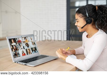 Distance Work From Home. A Young Multiracial Woman Is Using Laptop For Communication Via Video With 