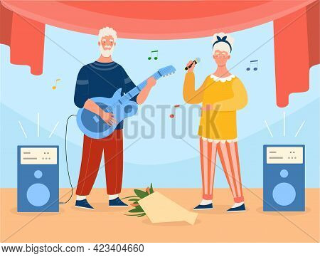 Grey Elderly Couple Is Playing Guitar And Singing On Stage. Concept Of Active Elderly People Full Of