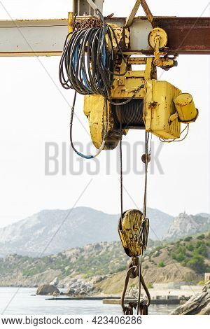 Electric Hoist On Beam With Hook. Sunny Autumn Day. Side View.