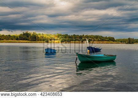 Small Open Colorful Rowboats Moored On Water. Post-mining Reservoir (artificial Lake) Pogoria Iv Bef