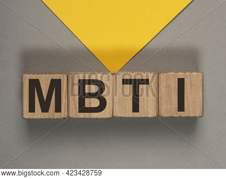 Mbti Acronym On Wood Cubes On Gray And Yellow Background. Psychological Test.
