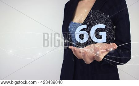 6g Network Internet Mobile Wireless Business Concept. Hand Hold Digital Hologram 6g Symbol On Grey B