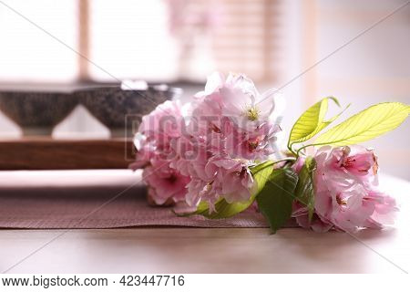 Sakura Flowers Near Cups On Table. Traditional Tea Ceremony