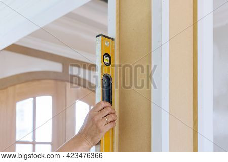 Worker Using Leveling Instrument Check Appropriate Wood Columns Using Level In Under Construction