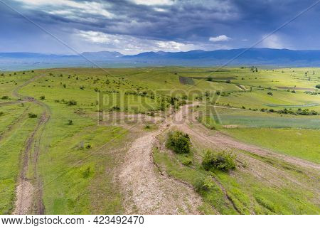 Aerial Drone View, Forest Roads On The Top Of The Green Hill At Summertime, Dramatic Stormclouds In 