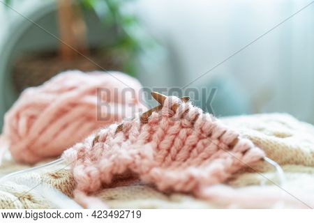 Wooden Knitting Needles With Knitting Made Thick Wool Yarn On Background Cozy Home Environment, With