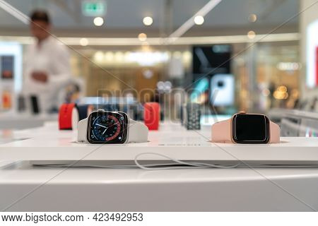 Multi-colored Apple Watch Series 6 In The Apple Store Window. Apple Authorized Shop. The Modern Shop