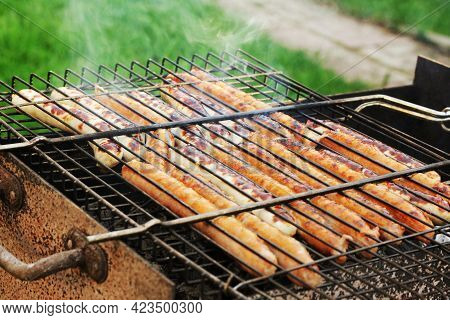 Preparing Kupati, Georgian Sausages On The Grill. Back Yard Picnic Concept.