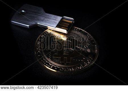 Bitcoin Coin And Usb Flash Drive On A Black Background Close-up. Symbolizes Digital Storage Of Crypt