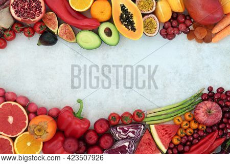 Plant based immune boosting vegan health food high in lycopene with fruit and vegetables also high in antioxidants, anthocyanins, vitamins, minerals,  and fibre. Border on mottled background.  