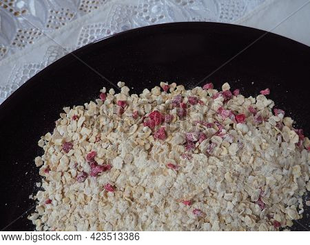Organic Granola Cereal With Oats, Powdered Sugar And Dry Raspberries. Healthy Muesli As A Dry Mix. A