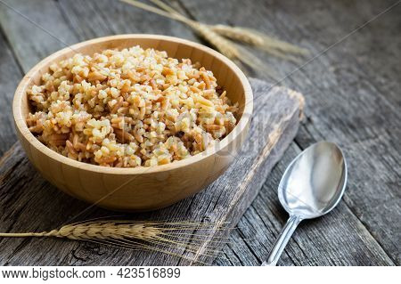 Traditional Turkish Food Bulgur Pilaf With Barley Noodle In Bowl On Wooden Background
