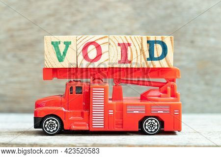 Fire Ladder Truck Hold Letter Block In Word Void On Wood Background