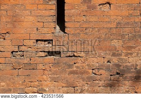 A Loophole In An Old Stone Wall. The Fortification Stone Wall Of An Ancient Castle With Loopholes. B