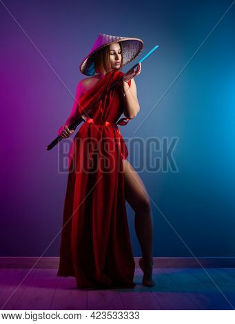 Sexy Woman In A Red Cape And An Asian Hat With A Katana In Her Hand Image Of A Samurai In Neon Color