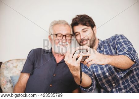Elder Looking Replay Photos From Digital Camera With His Son Happiness Family Moment With Digital De